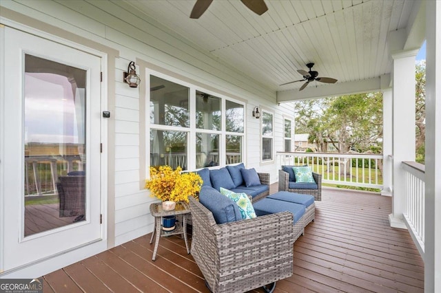 wooden deck with an outdoor hangout area, ceiling fan, and a porch