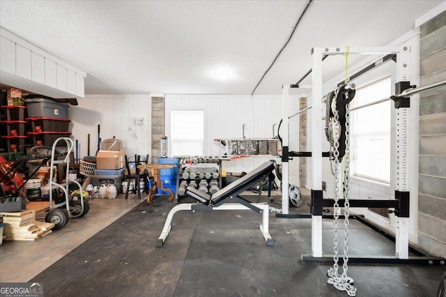 exercise room featuring a textured ceiling