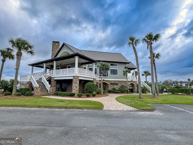 view of front of home with a porch and a front yard