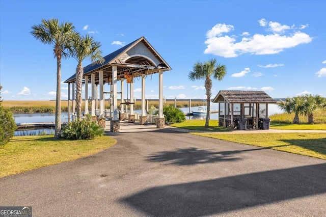 exterior space featuring a water view and a lawn