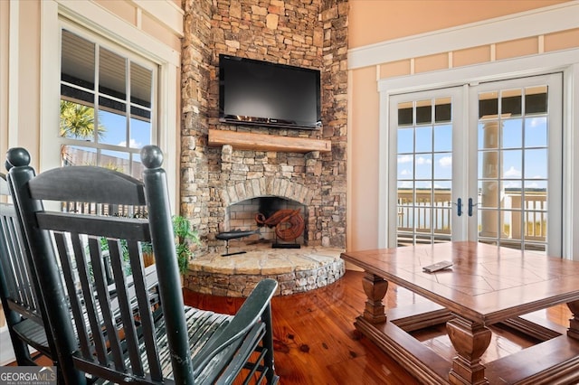 interior space with a fireplace, a wealth of natural light, and french doors