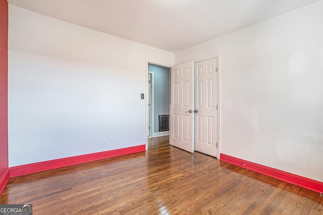 empty room featuring dark wood-type flooring