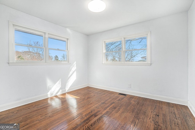 spare room with wood-type flooring