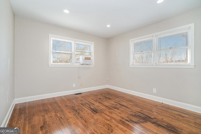 unfurnished room with hardwood / wood-style floors