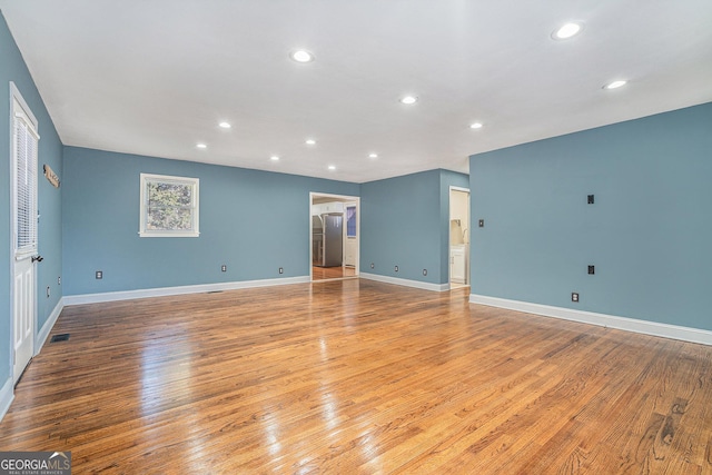 unfurnished room with light hardwood / wood-style floors