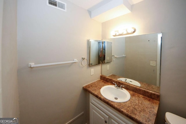 bathroom featuring vanity and toilet