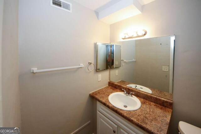 bathroom with vanity and toilet