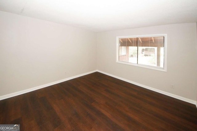 spare room featuring wood-type flooring