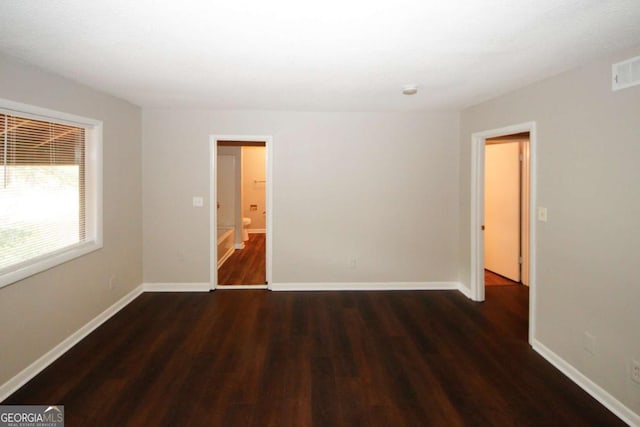 unfurnished room featuring dark hardwood / wood-style flooring