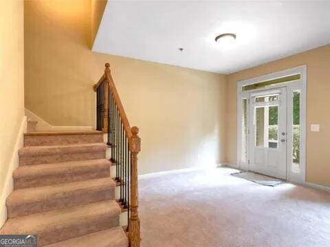 foyer with carpet flooring