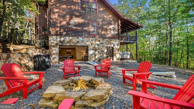 view of patio / terrace with a balcony and a fire pit