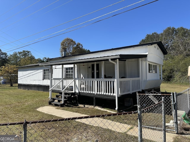 manufactured / mobile home with a porch and a front yard