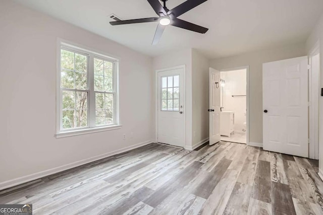 empty room featuring ceiling fan and light wood-type flooring