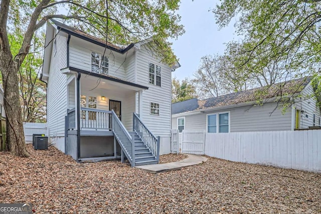 rear view of property with a porch and central air condition unit