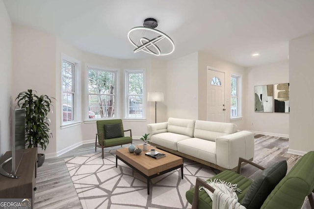 living room featuring light hardwood / wood-style floors and an inviting chandelier