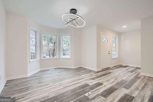 interior space featuring hardwood / wood-style flooring and a chandelier