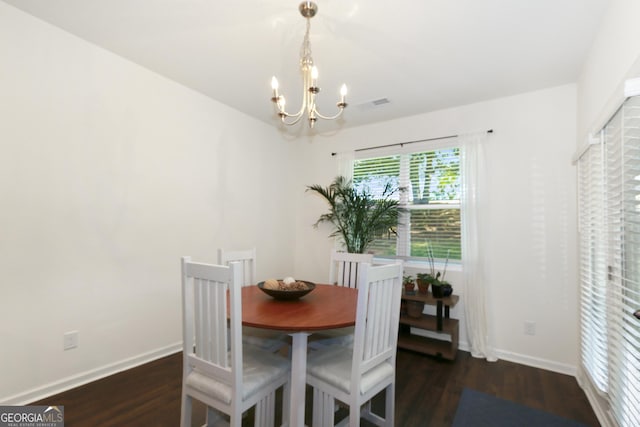 dining area with a chandelier and dark hardwood / wood-style floors