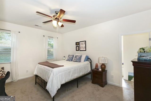 bedroom with light carpet and ceiling fan