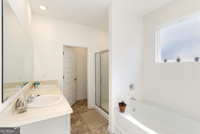 bathroom featuring vanity and independent shower and bath