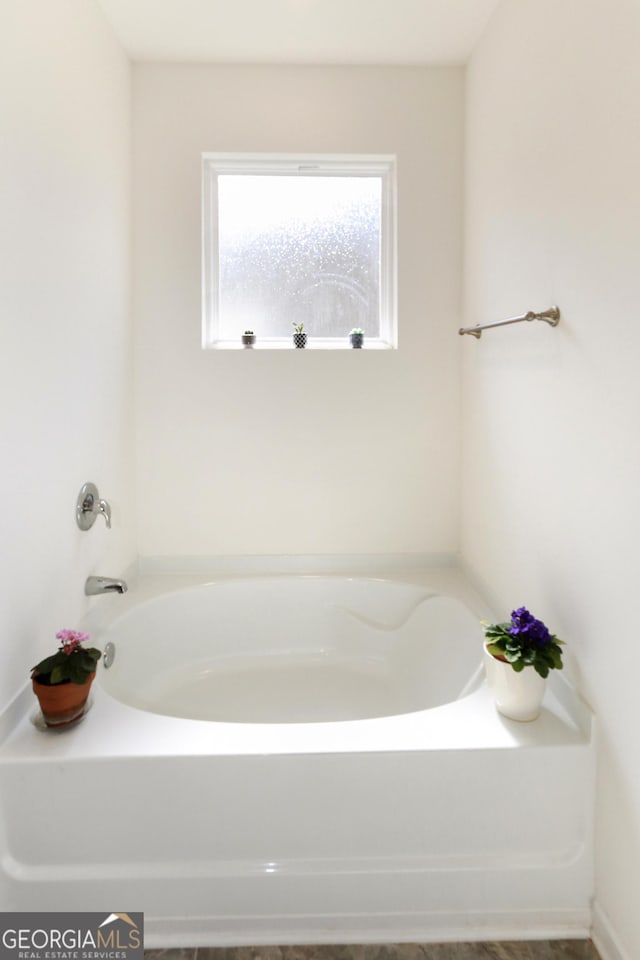 bathroom featuring a tub to relax in