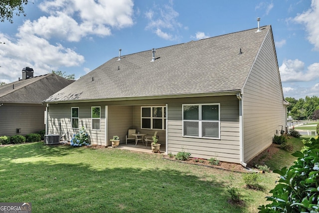 back of property with a patio area and a yard