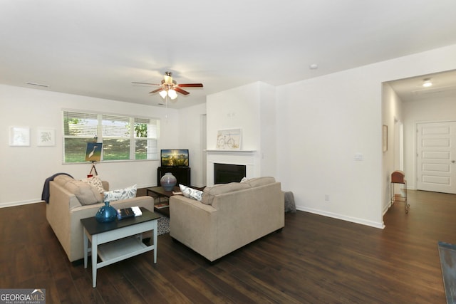 living room with ceiling fan and dark hardwood / wood-style floors