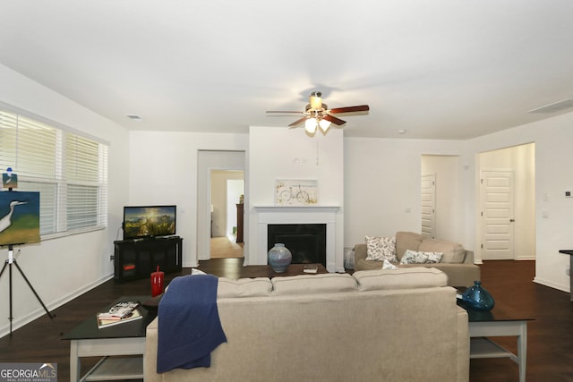 living room with ceiling fan and dark hardwood / wood-style floors