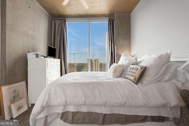 bedroom with ceiling fan, wood-type flooring, wooden ceiling, and multiple windows