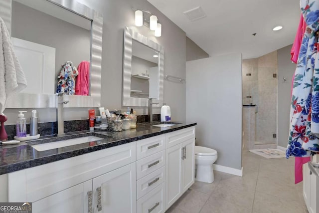 bathroom with tile patterned flooring, vanity, toilet, and an enclosed shower