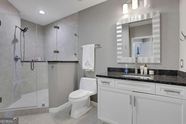 bathroom with tile patterned flooring, vanity, toilet, and an enclosed shower