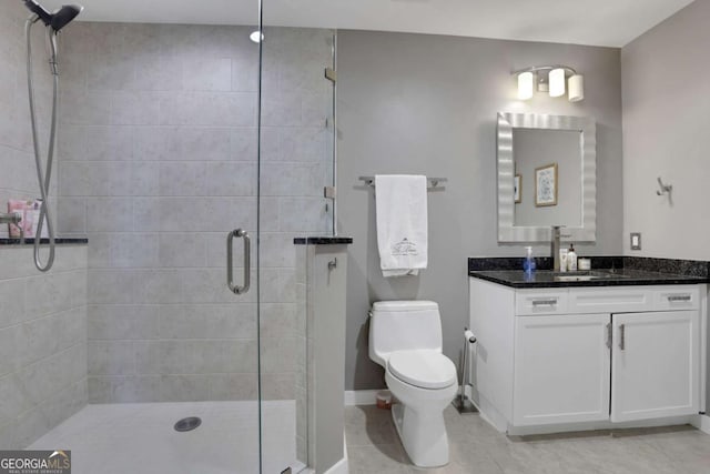 bathroom with tile patterned flooring, vanity, toilet, and a shower with door