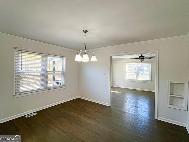 unfurnished dining area with dark hardwood / wood-style floors, ornamental molding, and ceiling fan with notable chandelier