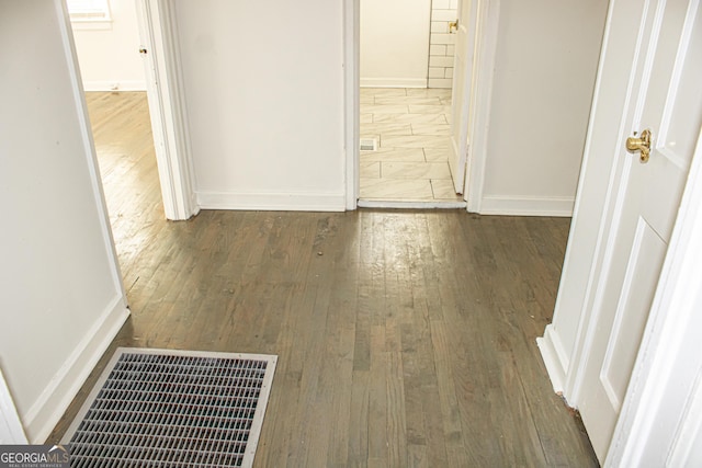 corridor with dark hardwood / wood-style floors