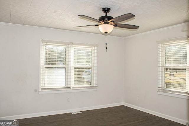 empty room featuring crown molding, dark hardwood / wood-style flooring, and ceiling fan