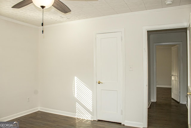 spare room with ceiling fan, dark hardwood / wood-style floors, and ornamental molding