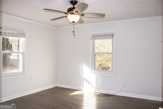 empty room with ceiling fan, crown molding, and dark wood-type flooring