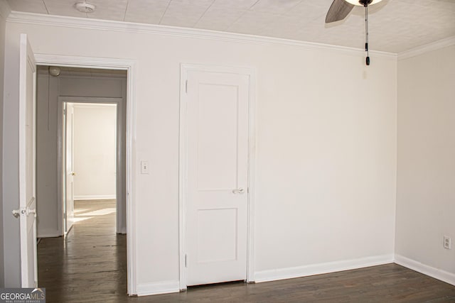 interior space with ceiling fan, dark wood-type flooring, and ornamental molding