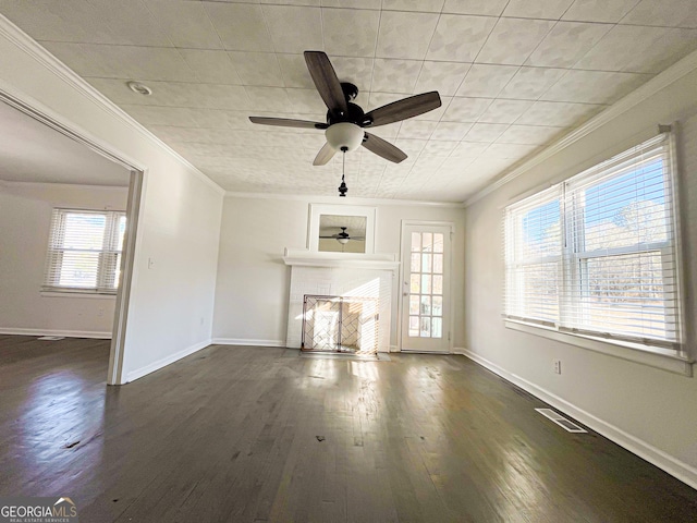 unfurnished living room with crown molding, ceiling fan, and dark wood-type flooring