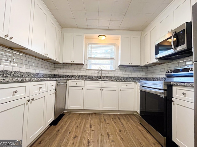 kitchen featuring light hardwood / wood-style floors, sink, white cabinetry, and stainless steel appliances