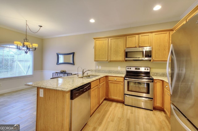 kitchen with kitchen peninsula, sink, light hardwood / wood-style flooring, and appliances with stainless steel finishes