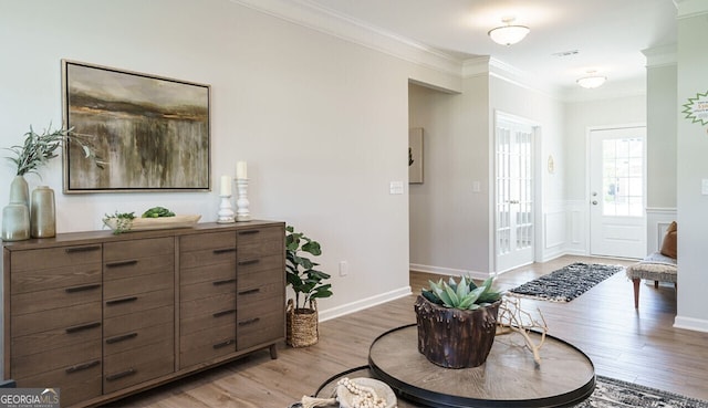 foyer featuring hardwood / wood-style floors and ornamental molding