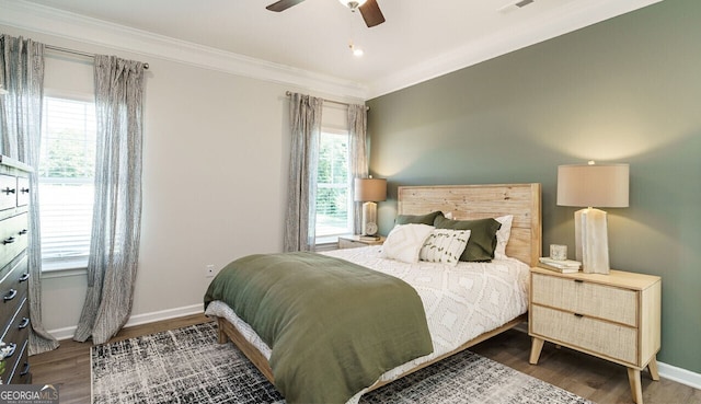 bedroom with ceiling fan, dark hardwood / wood-style flooring, and ornamental molding