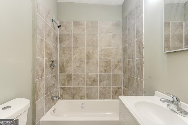 full bathroom featuring vanity, toilet, and tiled shower / bath