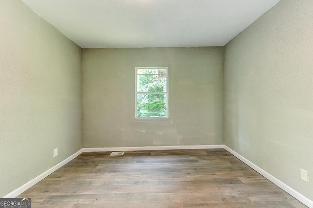 unfurnished room with light hardwood / wood-style floors