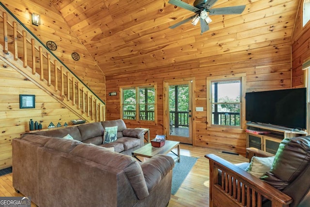 living room featuring light hardwood / wood-style floors, high vaulted ceiling, and wooden ceiling