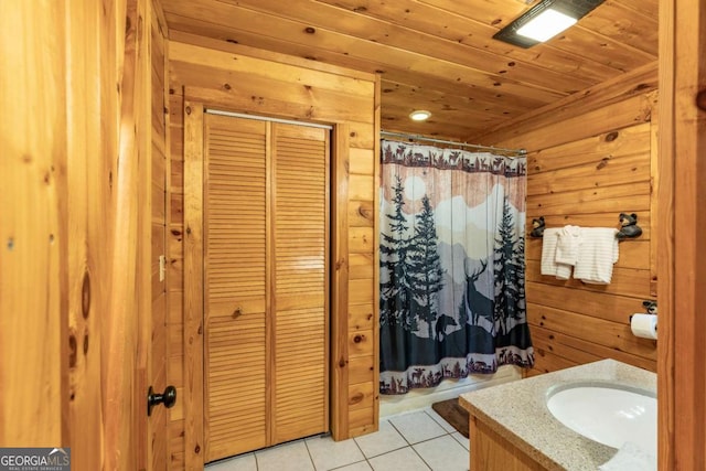 bathroom featuring curtained shower, wooden ceiling, tile patterned floors, wood walls, and vanity