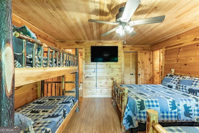 bedroom with wood ceiling and wooden walls