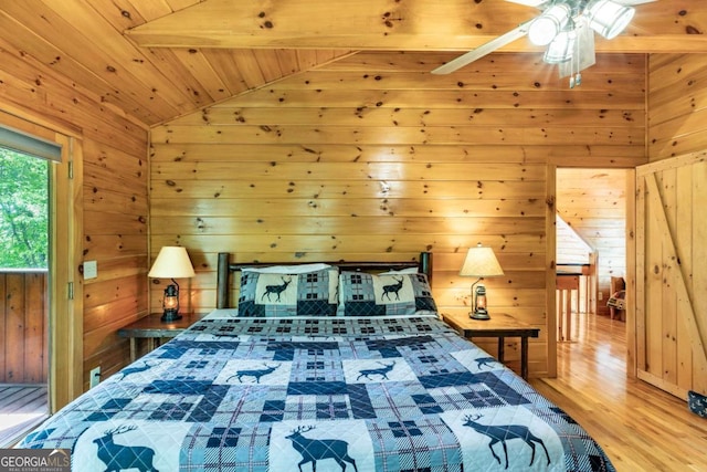 bedroom featuring lofted ceiling, ceiling fan, wooden walls, and wood ceiling