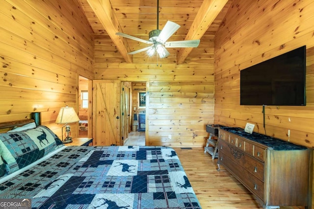 unfurnished bedroom featuring wood ceiling, ceiling fan, wooden walls, vaulted ceiling with beams, and light hardwood / wood-style floors