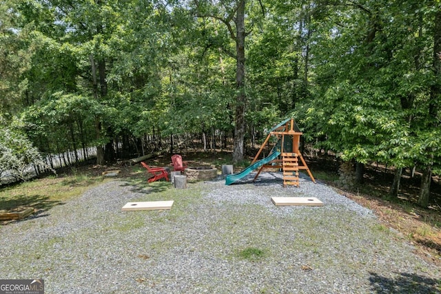 view of jungle gym featuring a fire pit